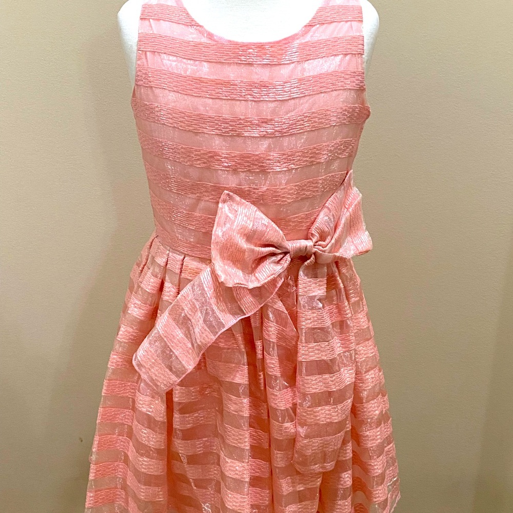 It a pretty in pink dress with a bow in the front, great condition.